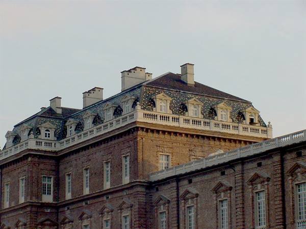 Reggia di Venaria: slate roof, dormer windows and brickwork under warm light