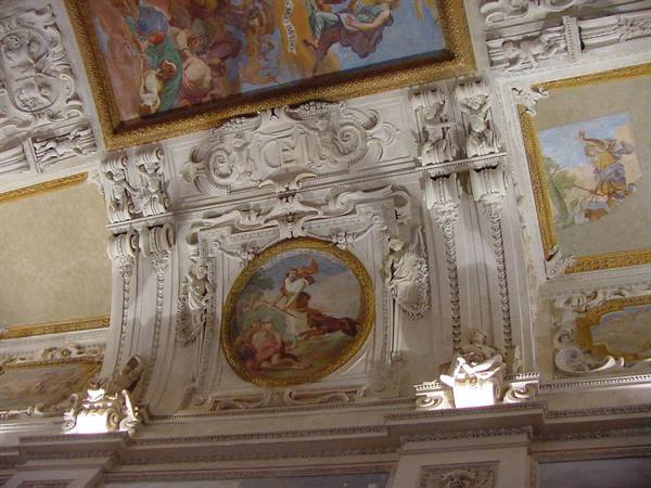 Baroque ceiling with white stucco reliefs and gold-framed mythological frescoes