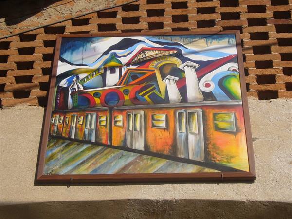 Colorful painting of train wagons mounted on a brick wall