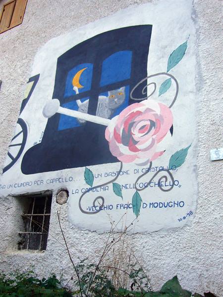 Mural on white wall: cat at window, painted rose and verses