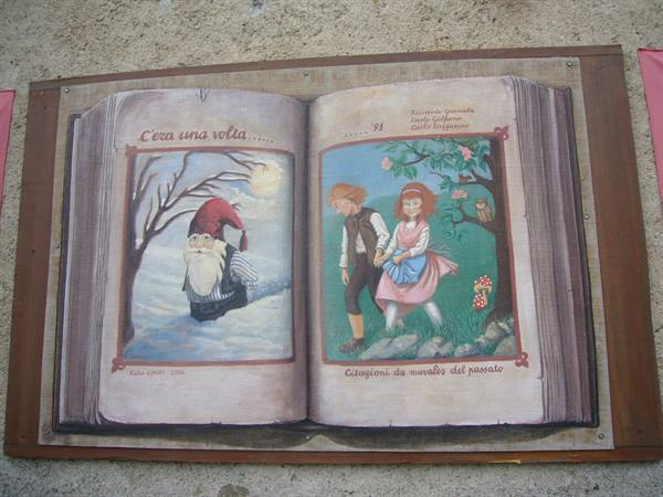 Mural painting shaped like an open book with illustrated fairy tales
