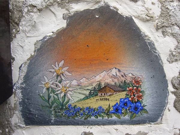 Hand-painted slate with edelweiss, flowers and mountain chalet