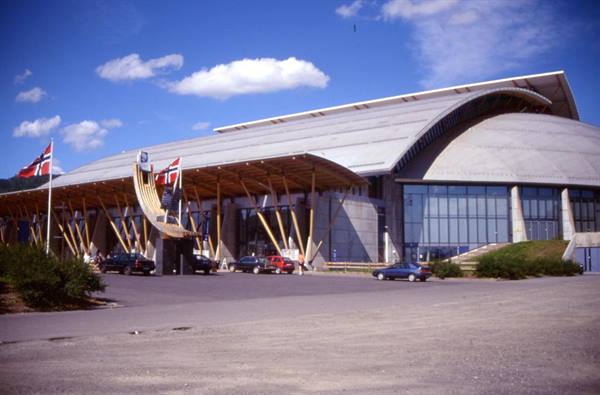 Vikingskipet arena in Hamar, curved wooden roof and glass, Norwegian flags