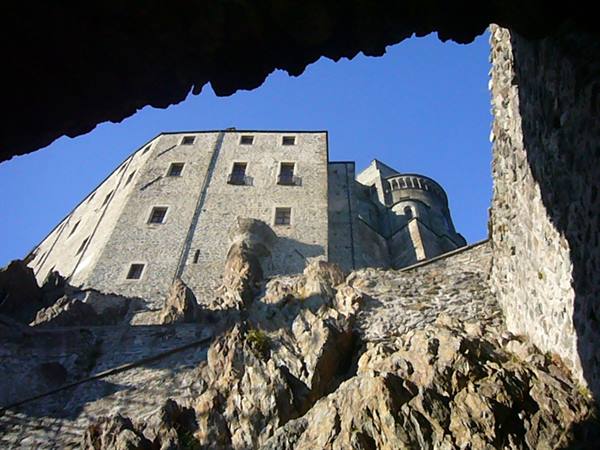 Sacra di San Michele: stone monastery atop the rock, blue sky