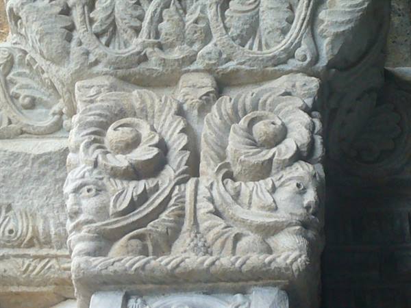 Romanesque stone capital carved with leaves and animal figures