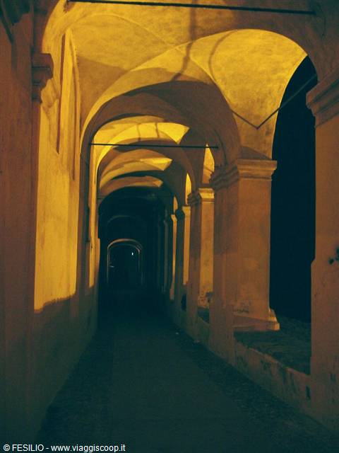 night stone arcade with vaults lit by warm yellow light