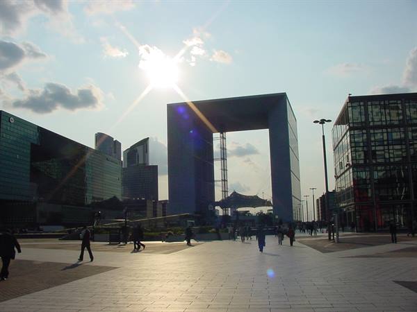 The Grande Arche at La Défense, Paris, pedestrians on the plaza against the sun