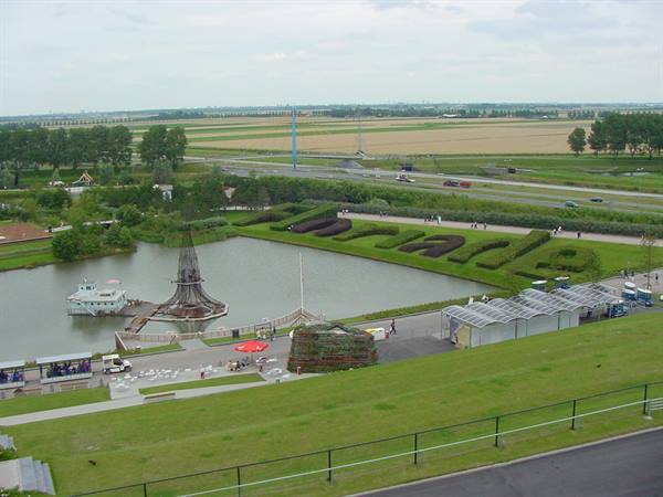 Madurodam park in The Hague: miniature models, pond and Dutch farmland under cloudy sky