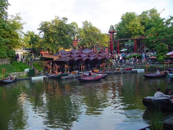 Boats on the lake at Tivoli Gardens, Copenhagen, pavilions and visitors