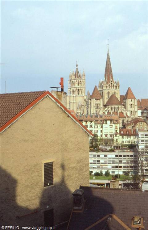 Lausanne Gothic cathedral rises among rooftops and buildings