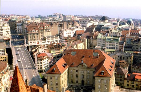 Red rooftops and historic buildings of Lausanne seen from above in daylight