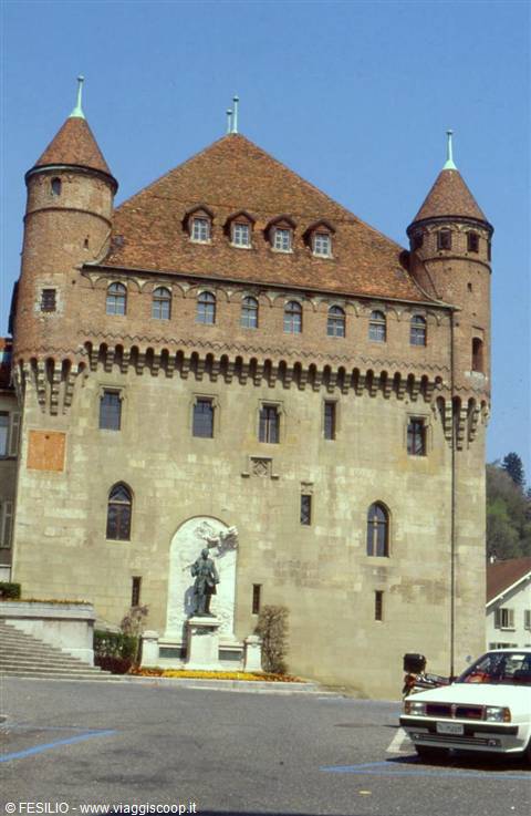 Saint-Maire Castle in Lausanne, brick towers, green roof, statue in front