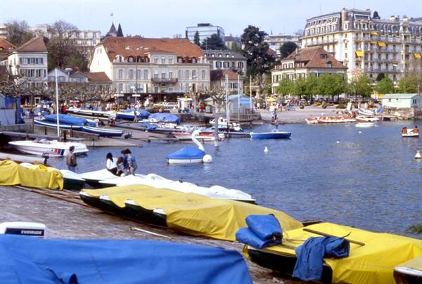 Yellow and blue covered boats on the quay at Ouchy, Lake Geneva
