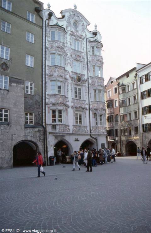 Tourists in front of the baroque facade of Helblinghaus in Innsbruck