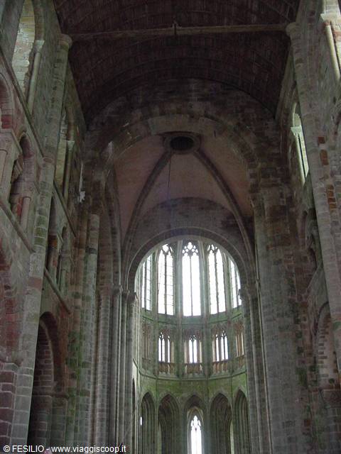 Gothic interior of Mont Saint-Michel abbey, stone vaults and light through windows