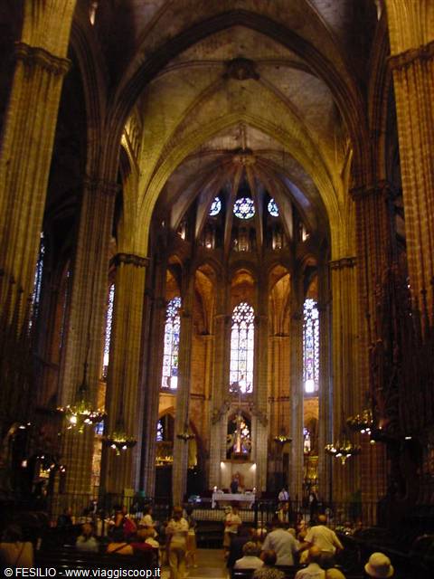Gothic interior of Barcelona Cathedral: columns, stained glass and visitors