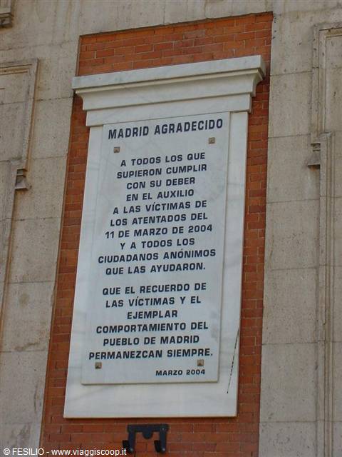 White marble plaque on a brick wall in Madrid, memorial to the attack victims