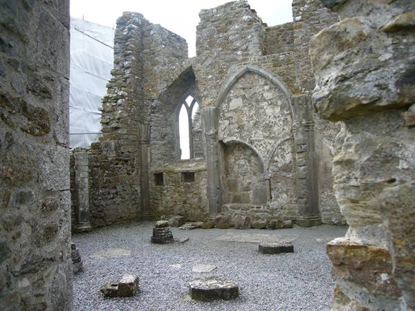 Medieval abbey ruins with weathered grey stone Gothic arches