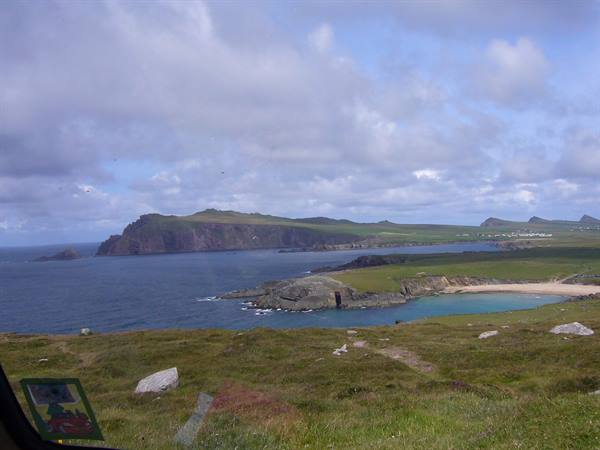 Sandy cove between green cliffs and blue sea, Dingle