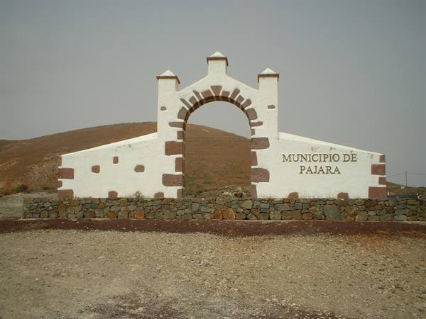 White stone arch reading Municipio de Pajara amid arid hills