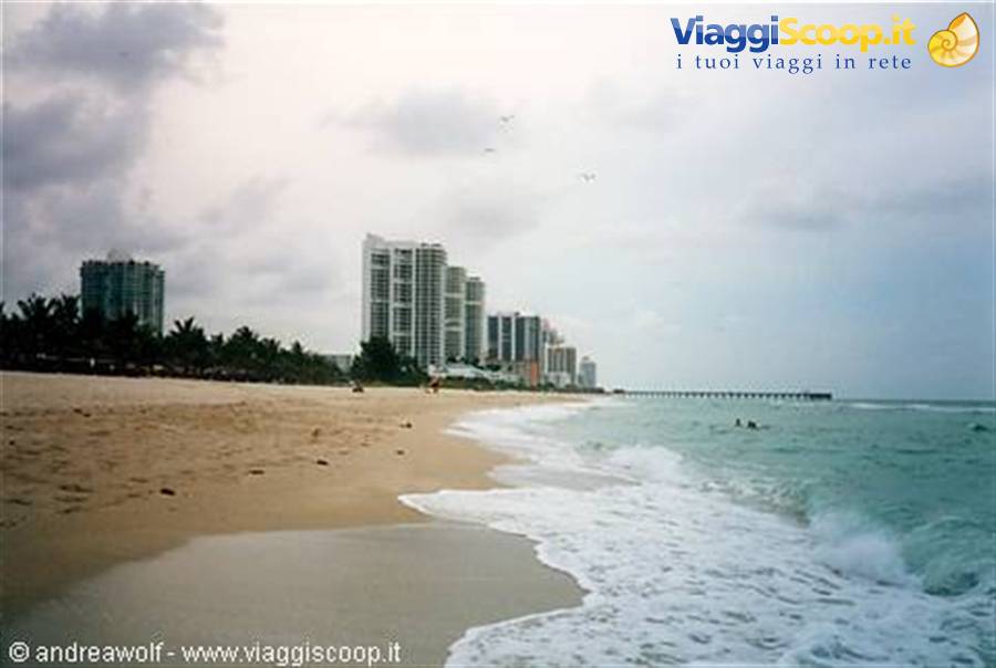 Waves on the sand in front of Miami Beach towers and pier