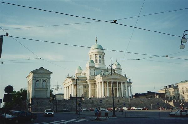 White Lutheran cathedral with green domes above Senate Square in Helsinki
