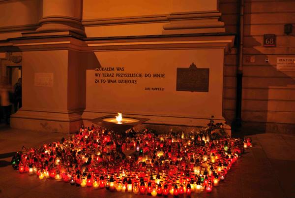 Eternal flame and hundreds of candles outside Kraków's Franciscan basilica