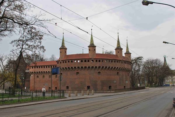 The red-brick Barbakan in Kraków, conical towers above medieval walls