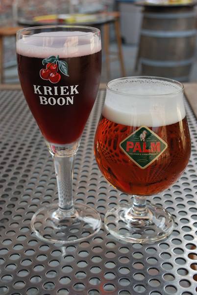 Kriek Boon and Palm beer glasses on a perforated steel table