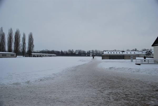 Dachau: barracks and guard tower across snowy ground, grey sky