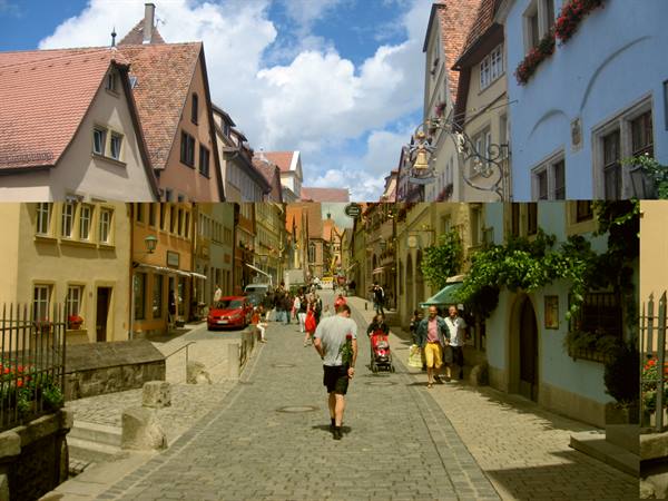 Cobblestone street with half-timbered houses and tourists in Rothenburg ob der Tauber