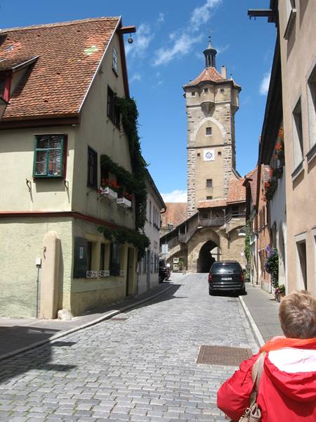 Cobblestone street toward Klingentor tower, half-timbered houses, Rothenburg