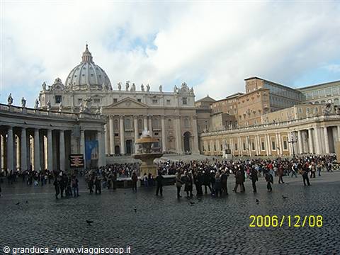 St. Peter's Square with the dome, fountain and crowds between the colonnades