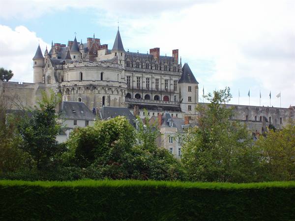 The Château d'Amboise rises above the trees under a cloudy sky