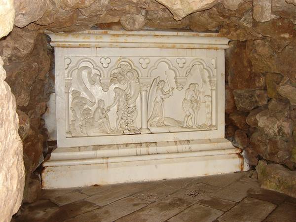 Marble relief with biblical scenes set inside a rocky grotto
