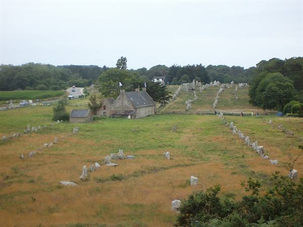 Rows of granite standing stones beside stone houses at Carnac