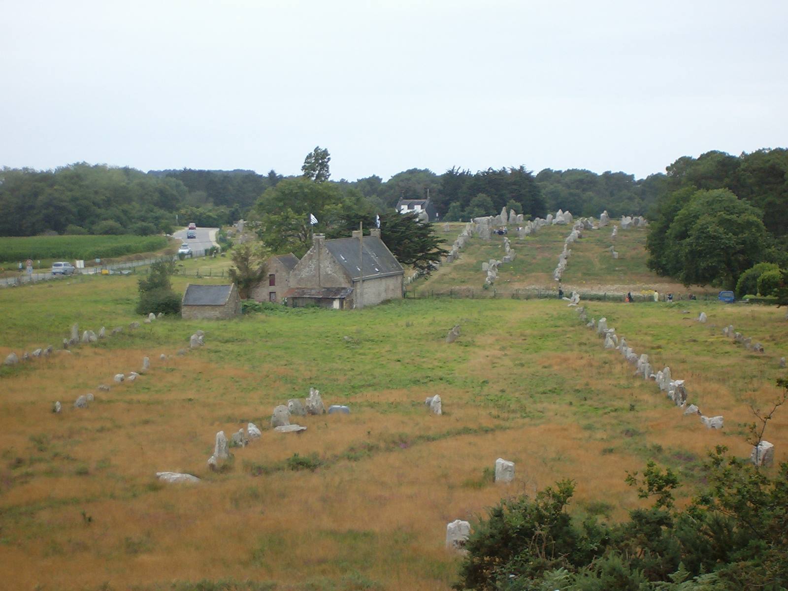 Rows of granite standing stones beside stone houses at Carnac