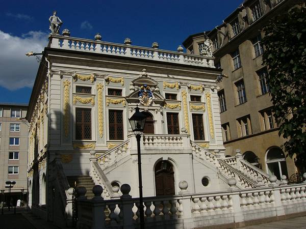 Leipzig's Old Stock Exchange, white baroque facade with golden ornaments and twin staircase