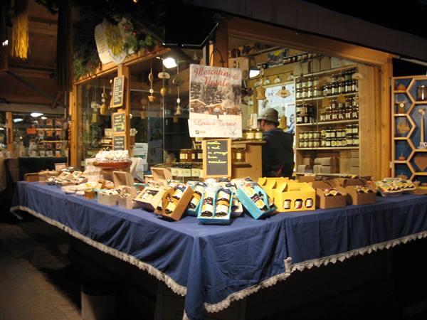 Wooden Christmas market stall selling honey jars and local products