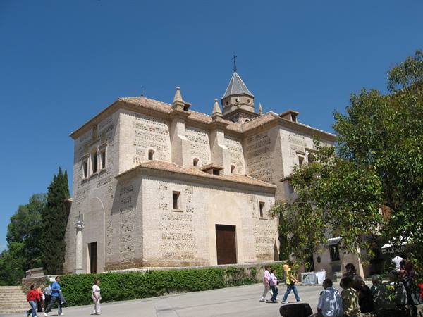 Tourists strolling past the mudéjar church of Santa María in the Alhambra