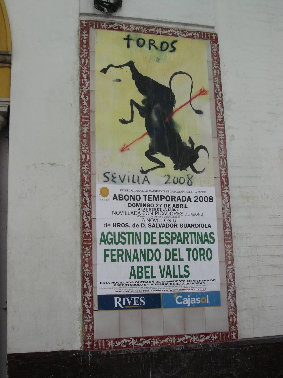 Bullfighting poster with black painted bull, Sevilla 2008, on white wall
