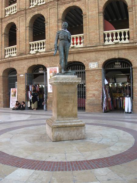 Bronze bullfighter statue on pedestal outside Valencia's Plaza de Toros