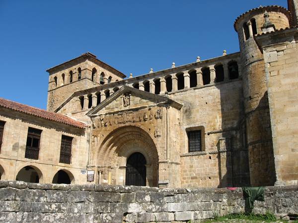 Romanesque Collegiate Church of Santillana del Mar, carved portal, golden sandstone, sunlight