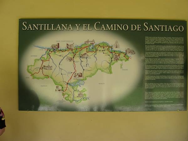 Illustrated map of the Camino de Santiago on a yellow wall in Santillana