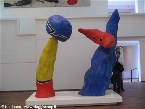 Colorful Joan Miró sculptures in the museum, a visitor nearby