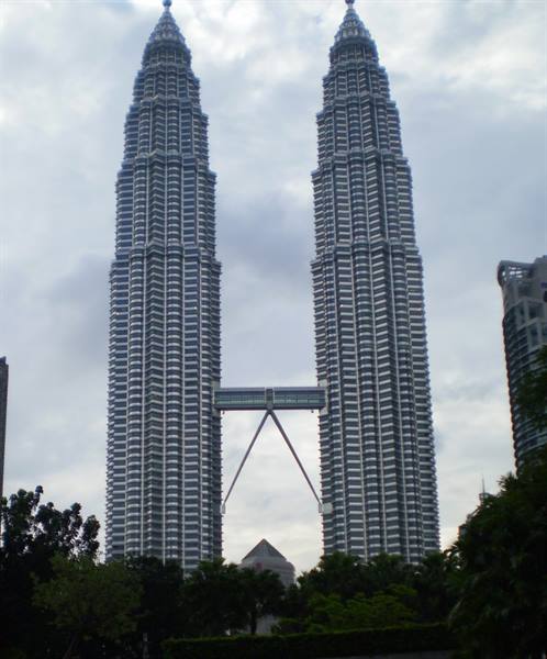 The Petronas Towers in Kuala Lumpur, steel and glass under cloudy sky