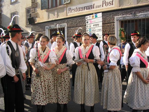 Girls in traditional folk costumes with musicians outside Restaurant zur Post