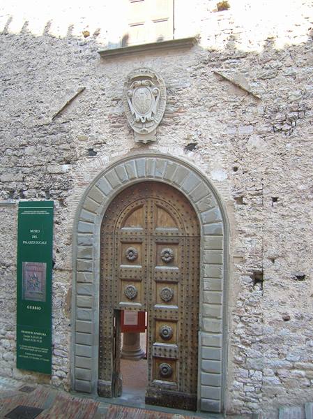Studded wooden door with stone coat of arms, Gubbio museum