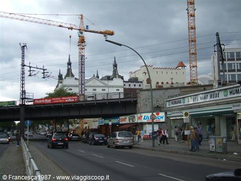 Construction cranes above shops and the railway bridge in Berlin