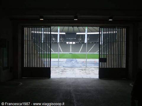 Open gates of the Olympiastadion reveal the green pitch and stands
